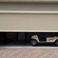Motorized patio and garage screens installed on a home exterior for sun and bug protection