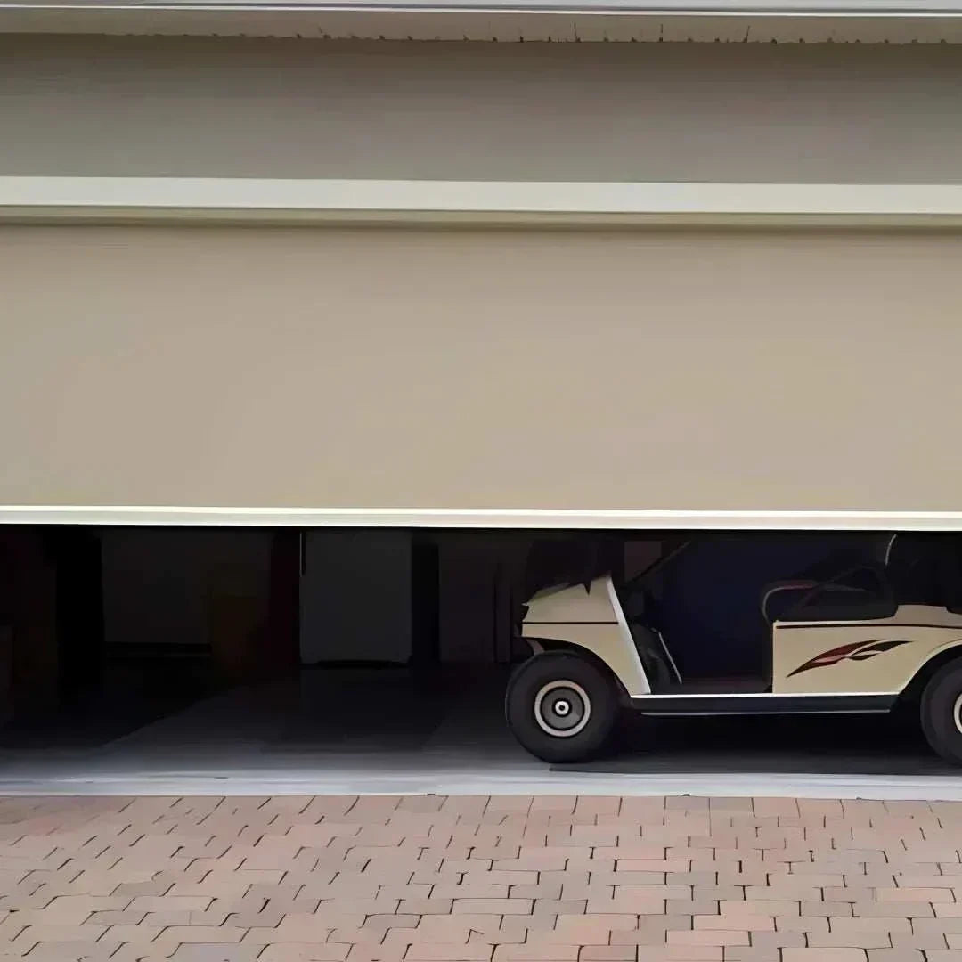 Motorized patio and garage screens installed on a home exterior for sun and bug protection