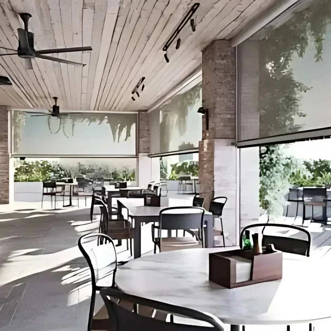 Motorized patio and garage screens installed on outdoor patio providing shade and bug protection