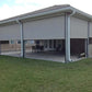Motorized patio and garage screens installed on a modern home exterior providing sun and bug protection